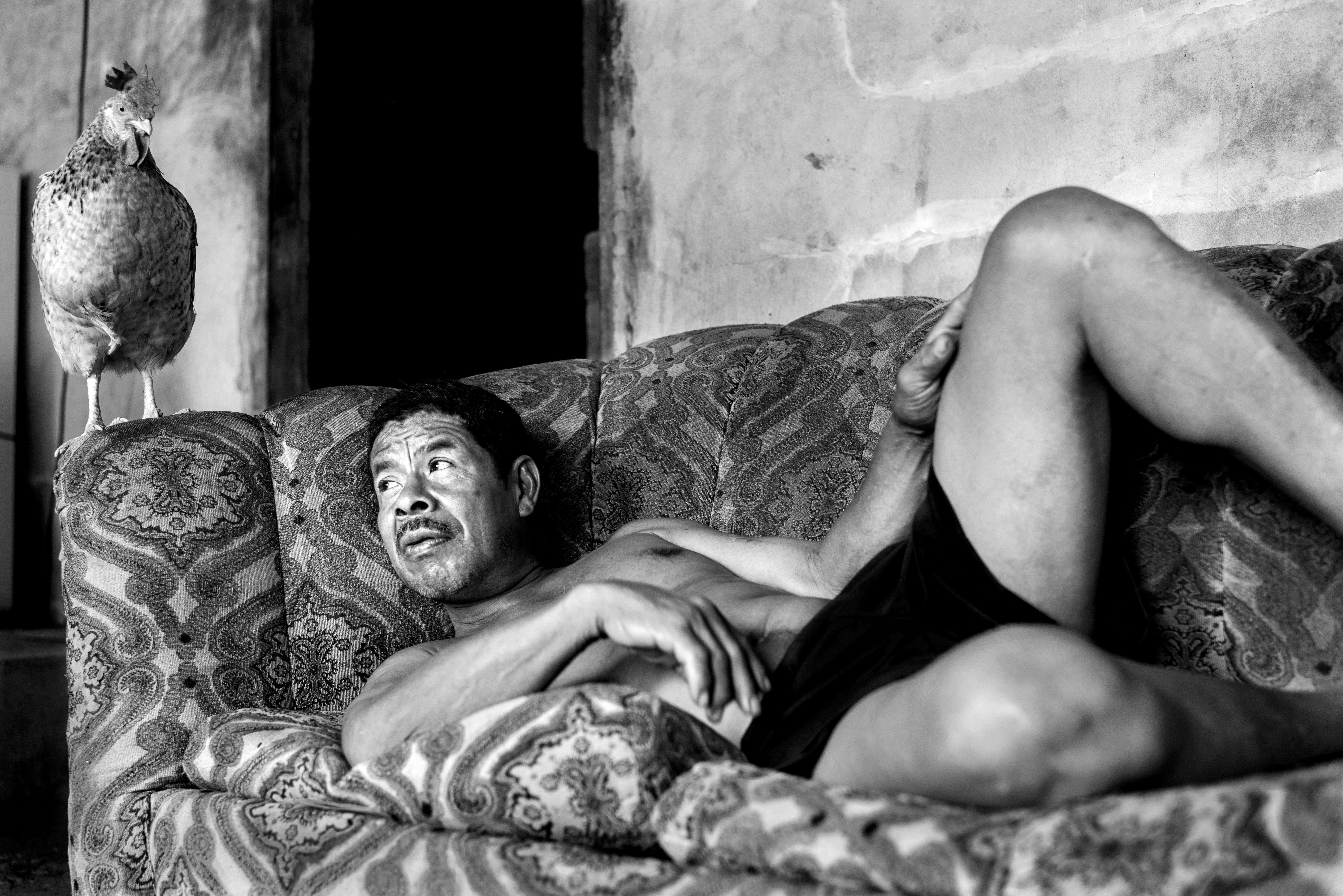 half naked man and chicken shot by photographer Horacio Marquinez in Panama